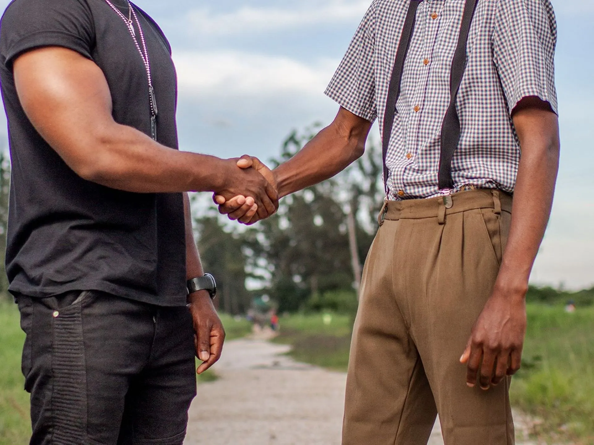 Two men shaking hands outdoors